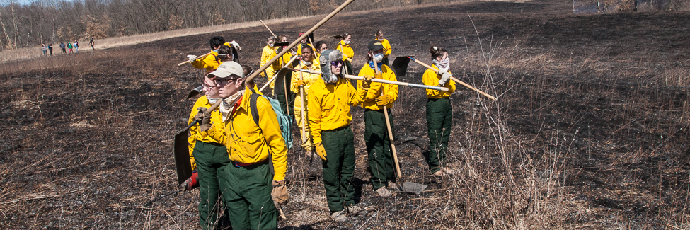 Professor Stuart Allison and students scan the burned prairie at Green Oaks.