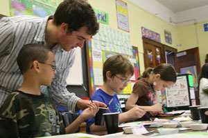 A Knox College student works with students at a Galesburg elementary school.
