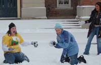 Students throw snowball on the south lawn of Old Main