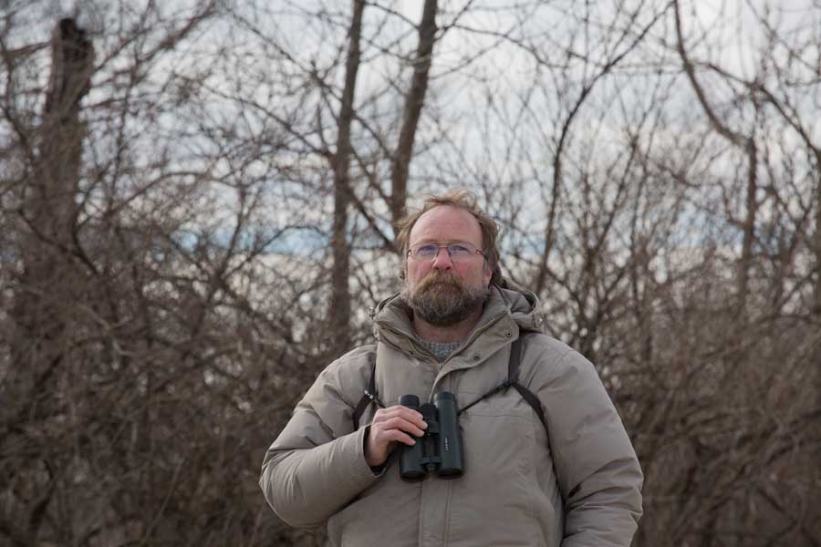 Knox College biology professor James Mountjoy with binoculars at the annual National Audubon Christmas Bird Count in Knox County.