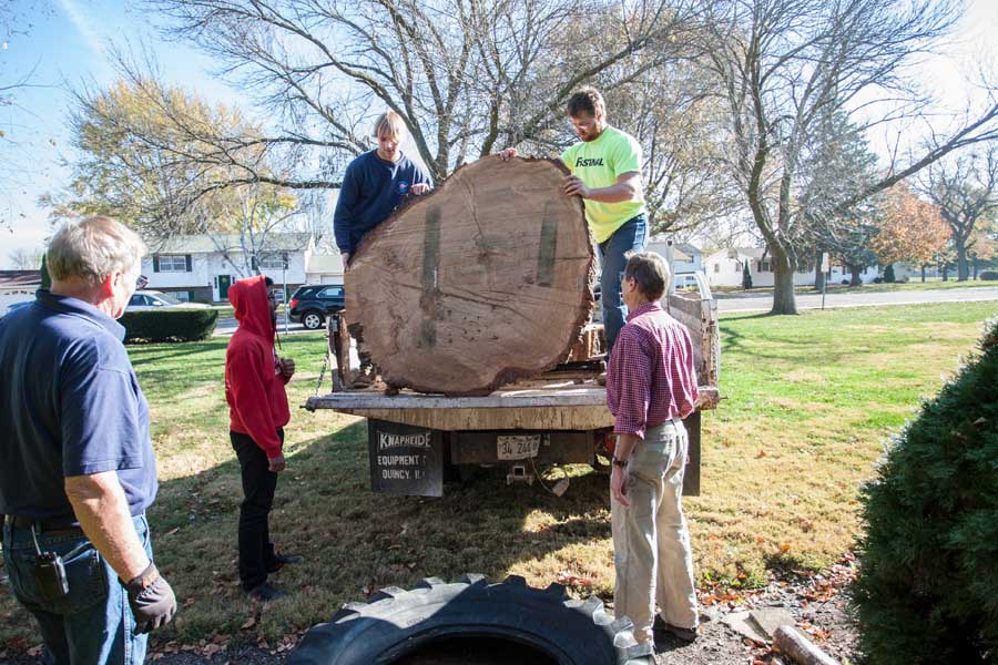 Knox College biology professor Stuart Allison delivers section of oak tree to Costa Catholic Academy in Galesburg.