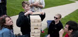 Students play Jenga on the campus lawn.