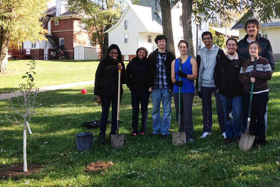 Students plant fruit trees during the Prairie Fire Bioneers Conference.