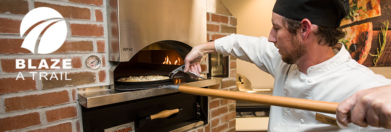 Loading the pizza oven