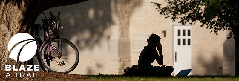 A Knox College student in front of Seymour Library