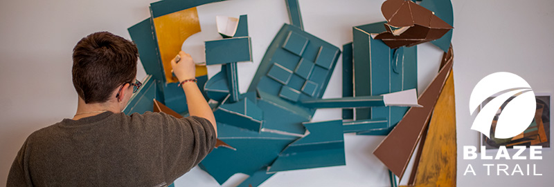 A Knox College student creating a sculpture in the Whicomb Art Center
