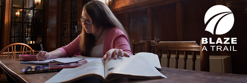 A Knox College student studies in the library