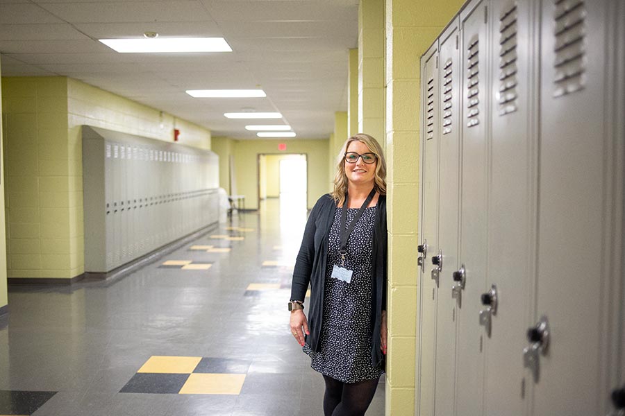 Mindi Ritchie '99 stands near a wall of lockers at Galesburg High School North, where she serves as principal.