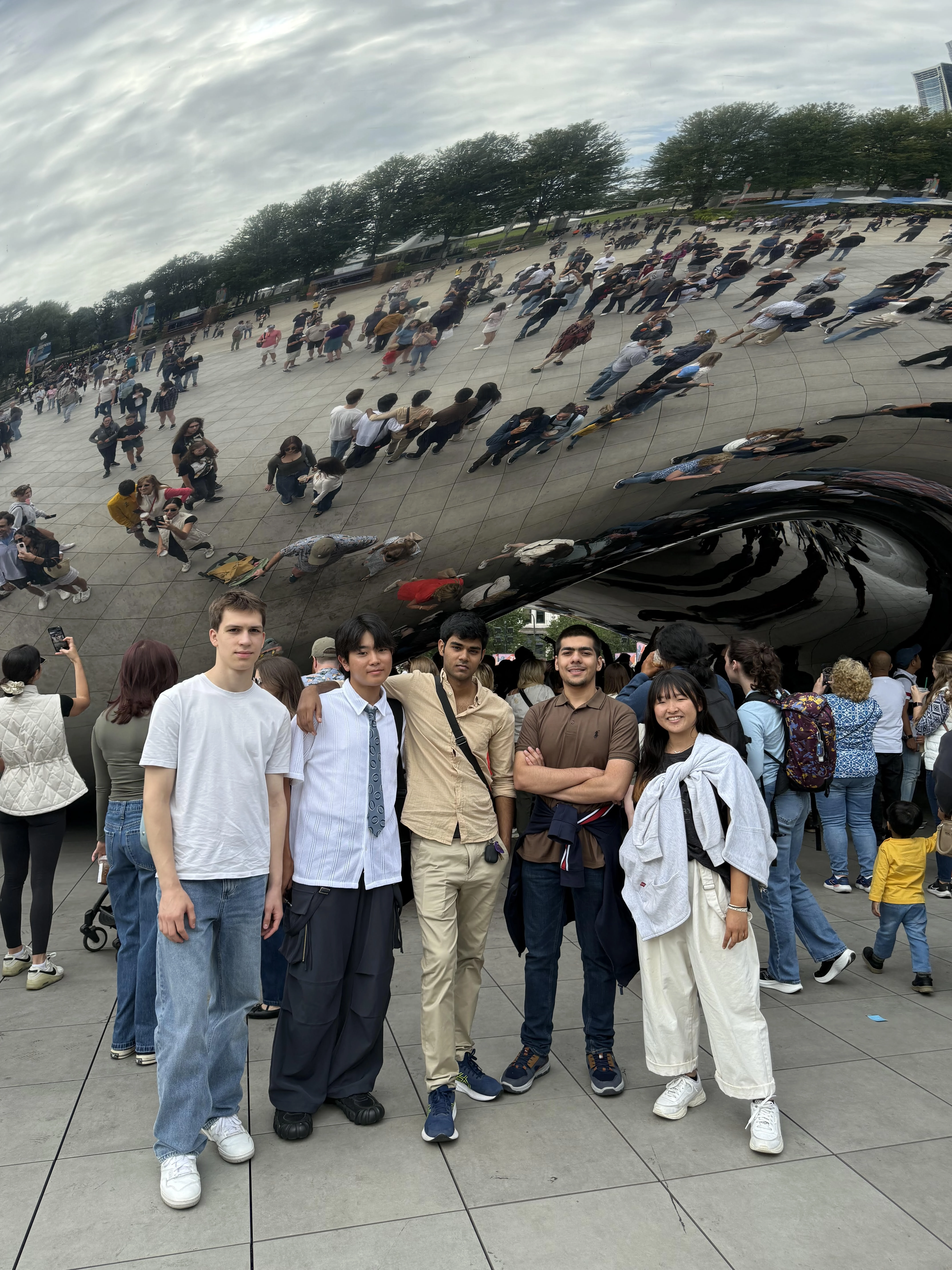 students posing outside the bean