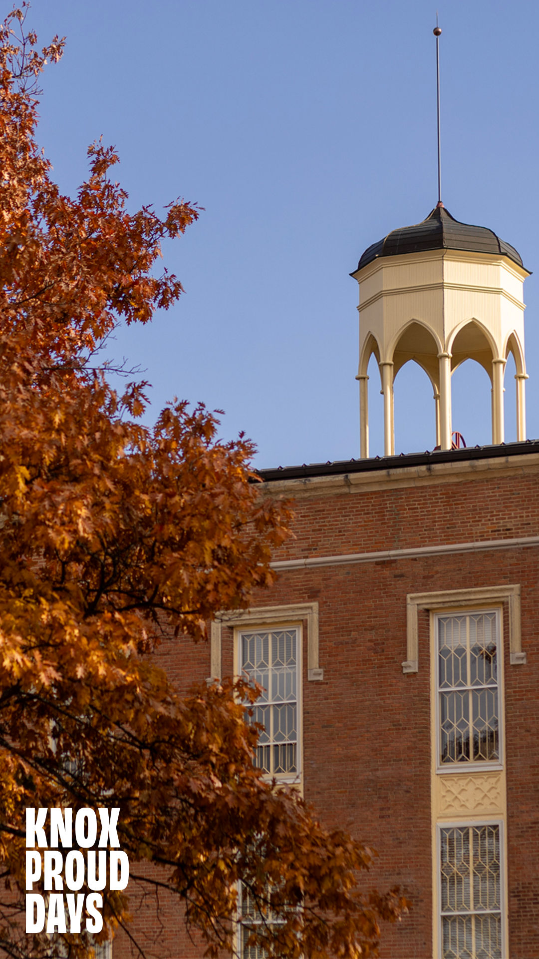 The belltower of Old Main is visible with a tree with autumn leaves to the left of it. Knox Proud Days is on the bottom left of the photo.
