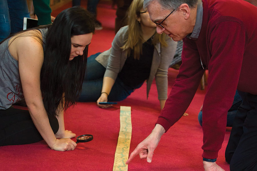 Students view a "ribbon map" in the Knox College Special Collections & Archives.