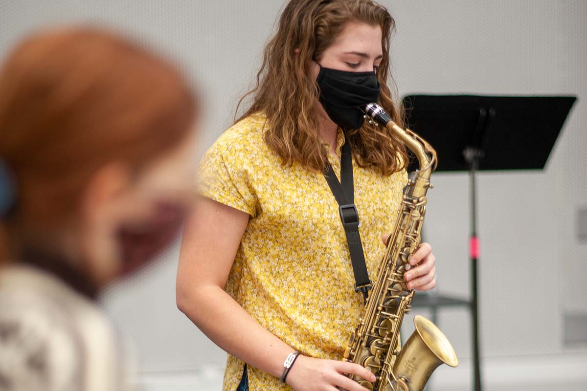 Saxophonist Clare Hensley '21 wears a special face mask that keeps her nose and mouth covered but allows her to play her instrument.