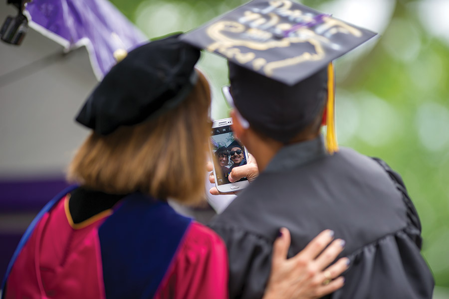 Teresa takes a selfie with a student at Commencement 2014.