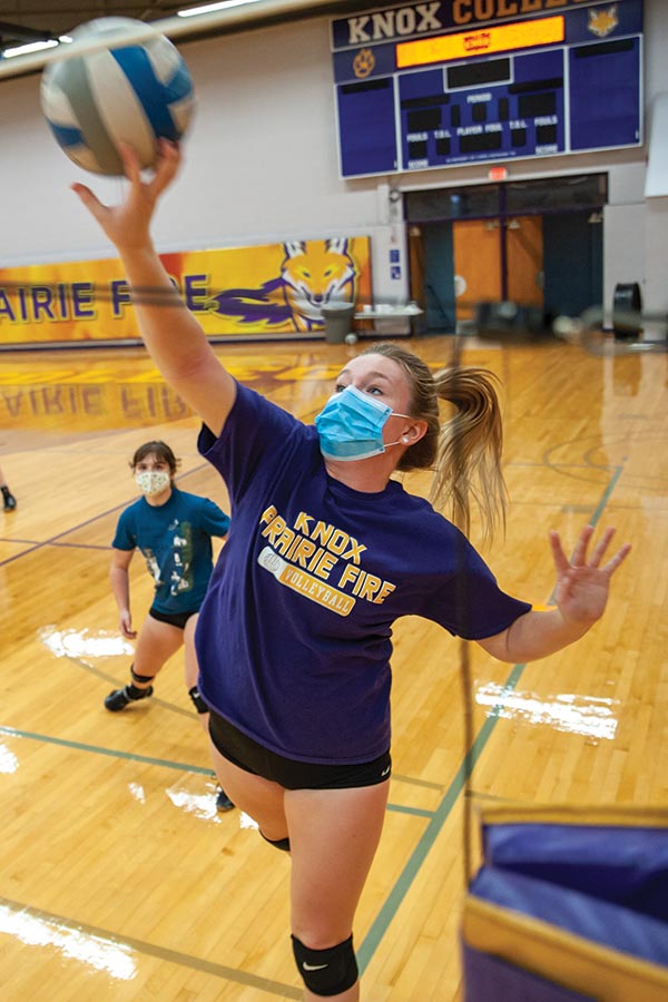 Maya McEwen '23 reaches for a ball during practice as Kaitlyn Kashishian '23 backs her up.