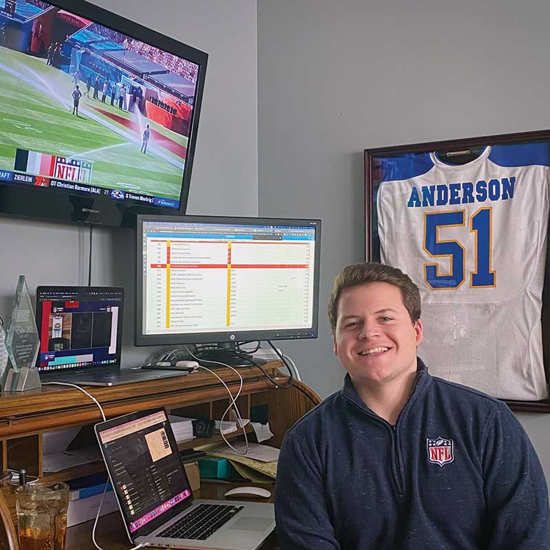 Andrew Isaacson ’99 takes a gameday selfie with one of the enormous video displays he managed during the game.