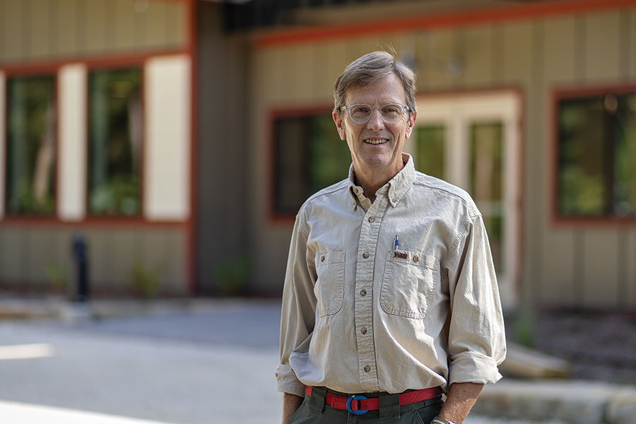 Stuart Allison stands in front of the new Knight Living & Learning Center.
