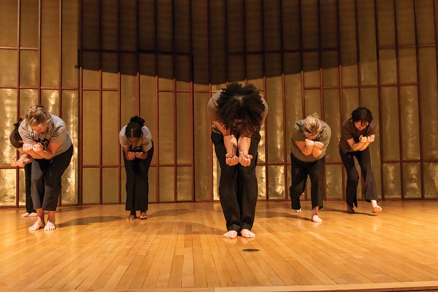 A group of students perform on stage.