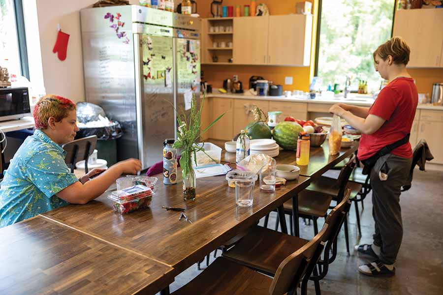 Students sit at a long table.