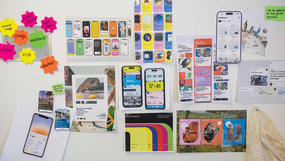 A white wall with colorful notes, pictures, and ideas pinned to it.