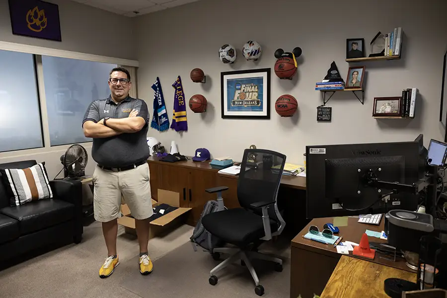 Justin Newell stands in his office with his arms crossed.