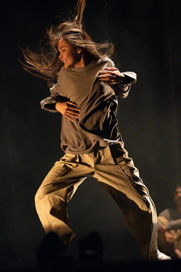 A student dances on stage.