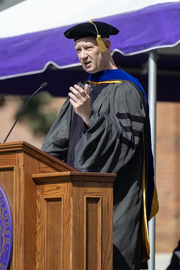 Mark Shroyer stands at a podium speaking.