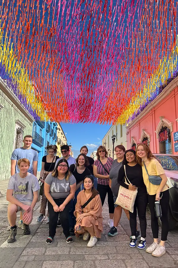 Szold Distinguished Service Professor of Modern Languages Robin Ragan (in sunglasses)  poses with students studying healthcare, social work and education in Oaxaca, Mexico in 2018.