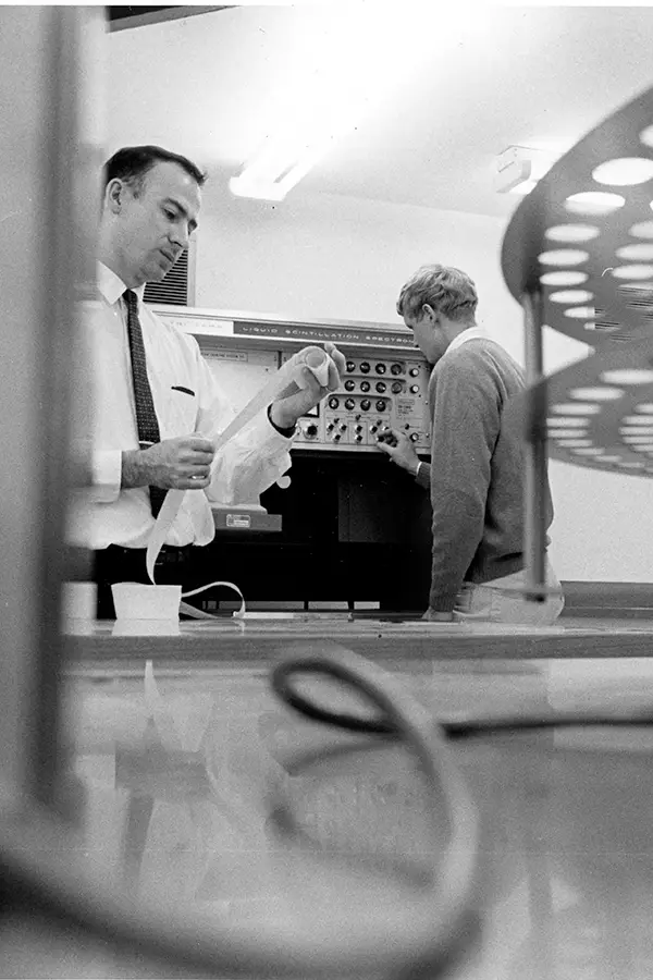 Professor Geer and a student working in the lab