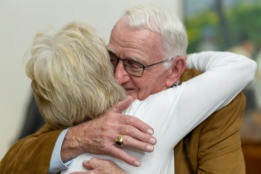 Harley Knosher greets a fellow Homecoming attendee with a hug. 