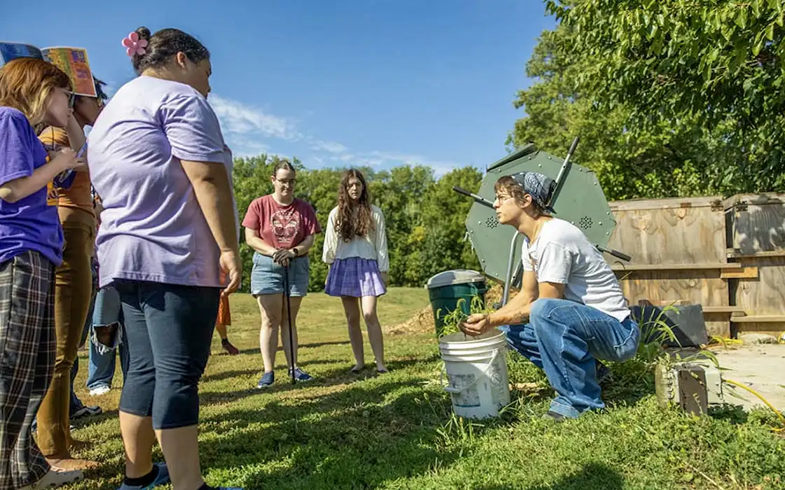 A student works on attaching the seat to a bicycle in the Knox College on-campus bike shop.