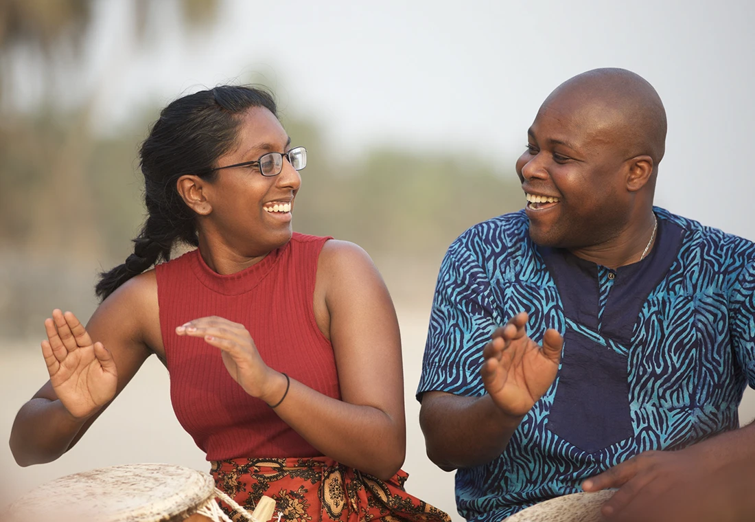 A Knox student in Ghana dances wtih a drummer playing beside them.