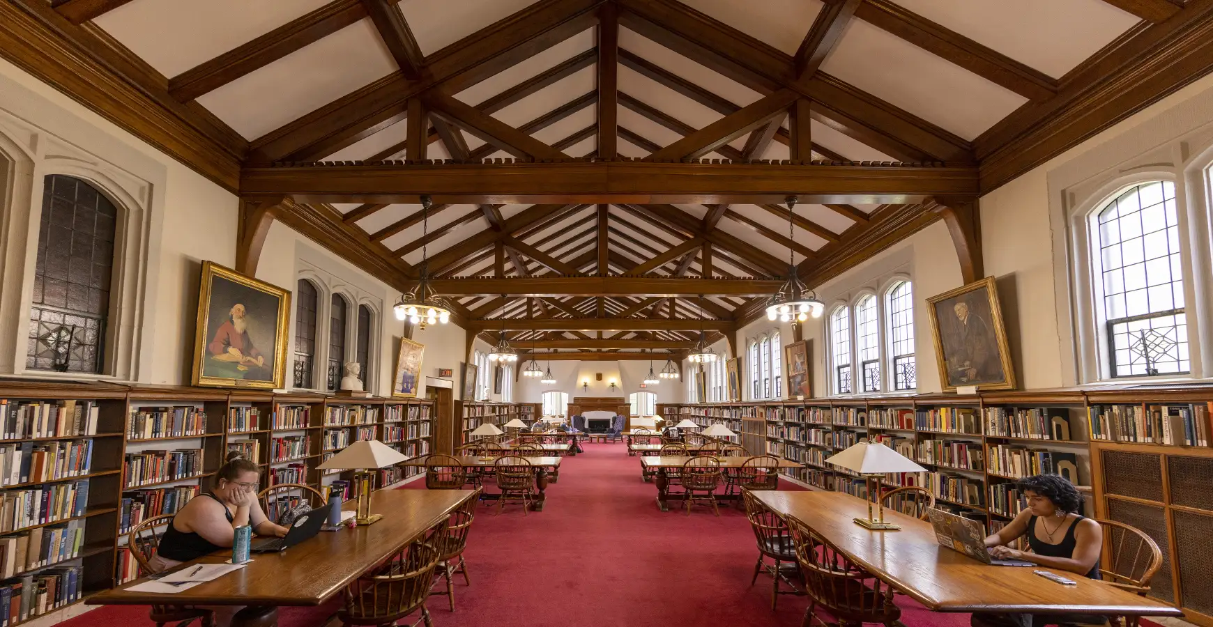 View of the Red Room in Seymour Library; two students are studying at tables.