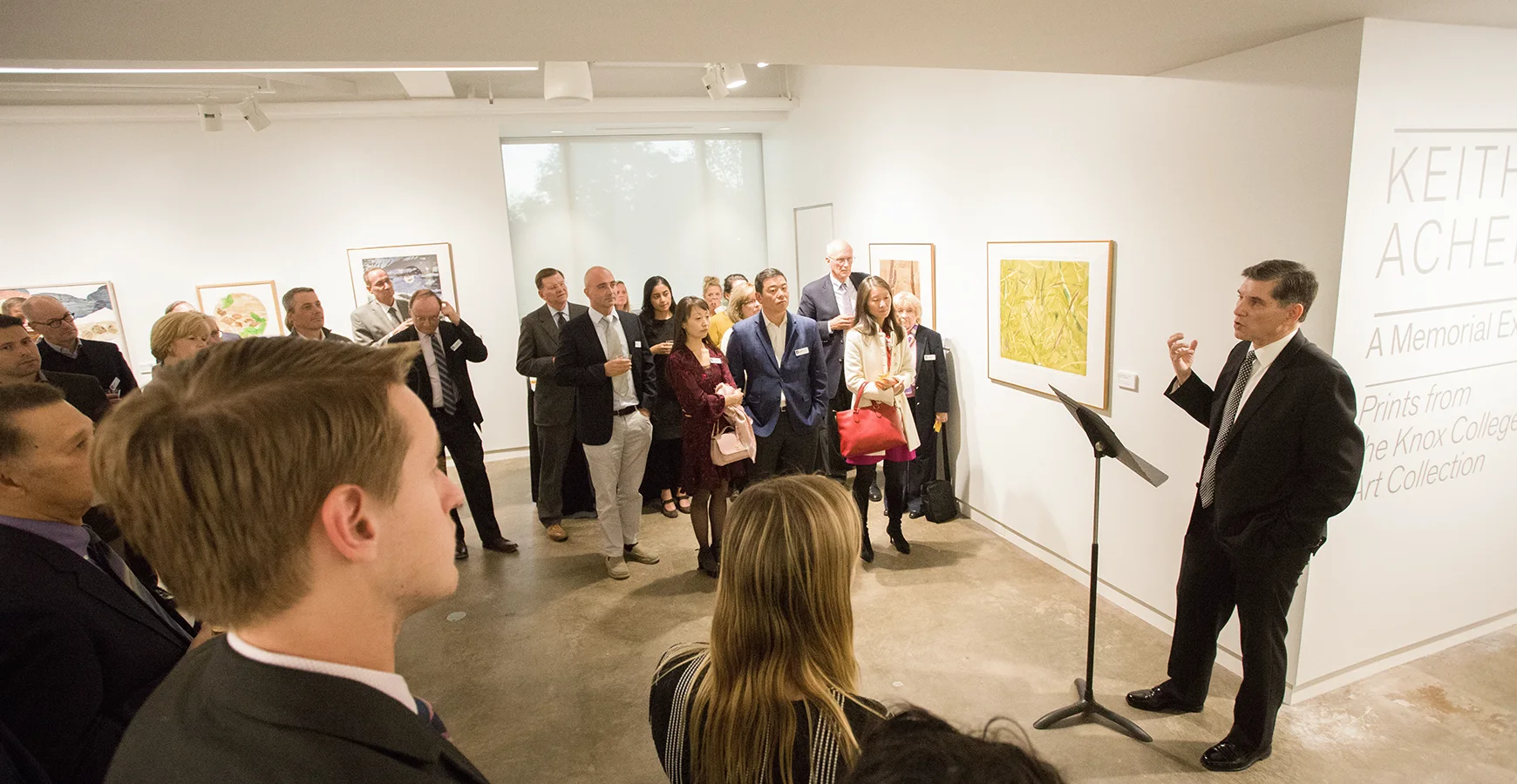 During the opening of the Borzello Gallery, Art History Professor Greg Gilbert stands in front of a crowd and speaks.