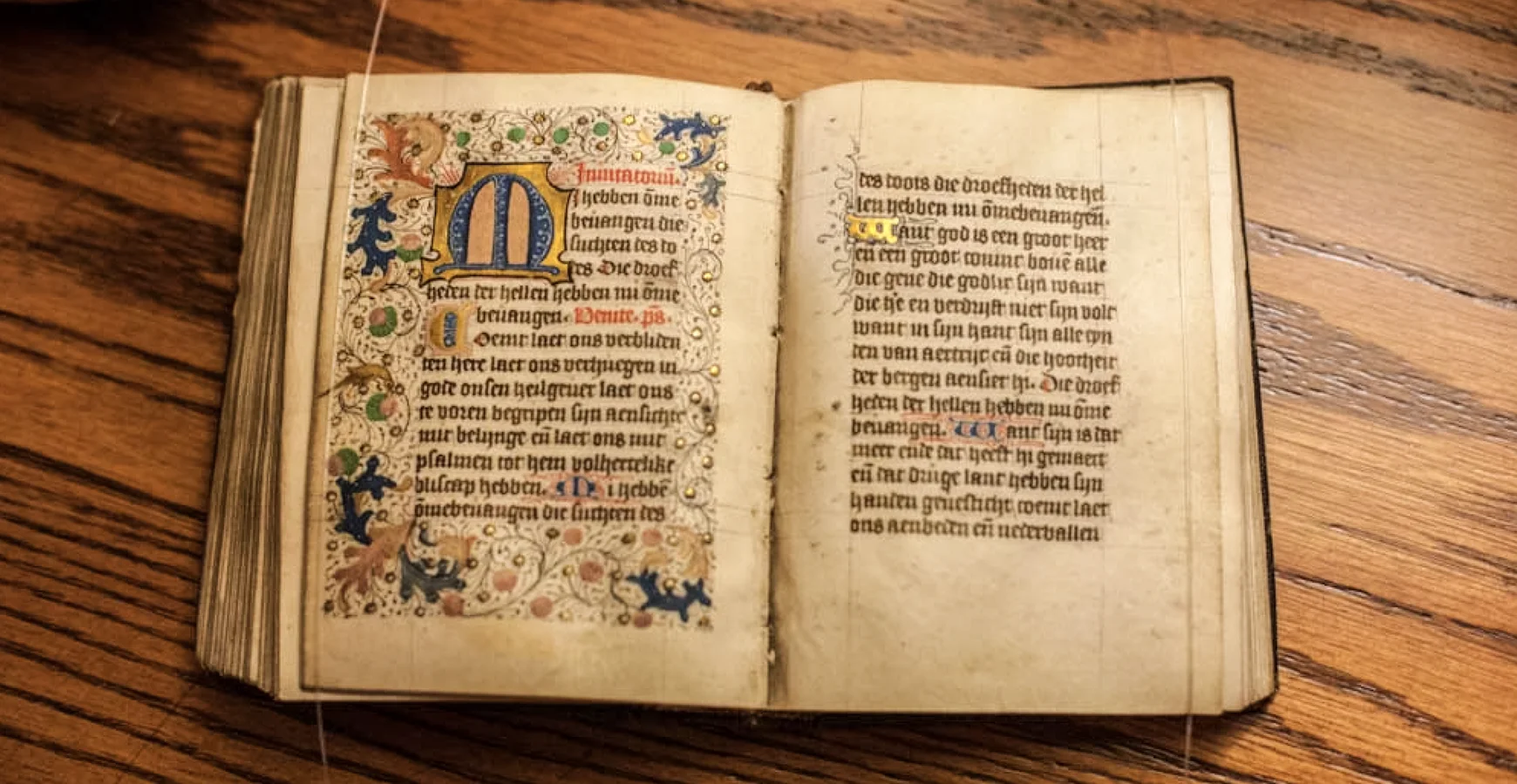 An illuminated manuscript from the Seymour Library's Special Collections & Archives lies open on a desk.