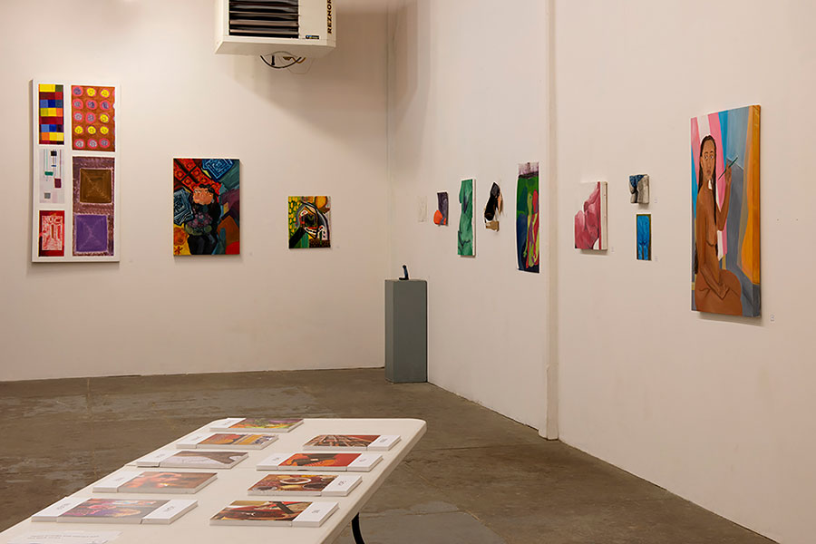 Works of art hang on the wall in an art gallery.