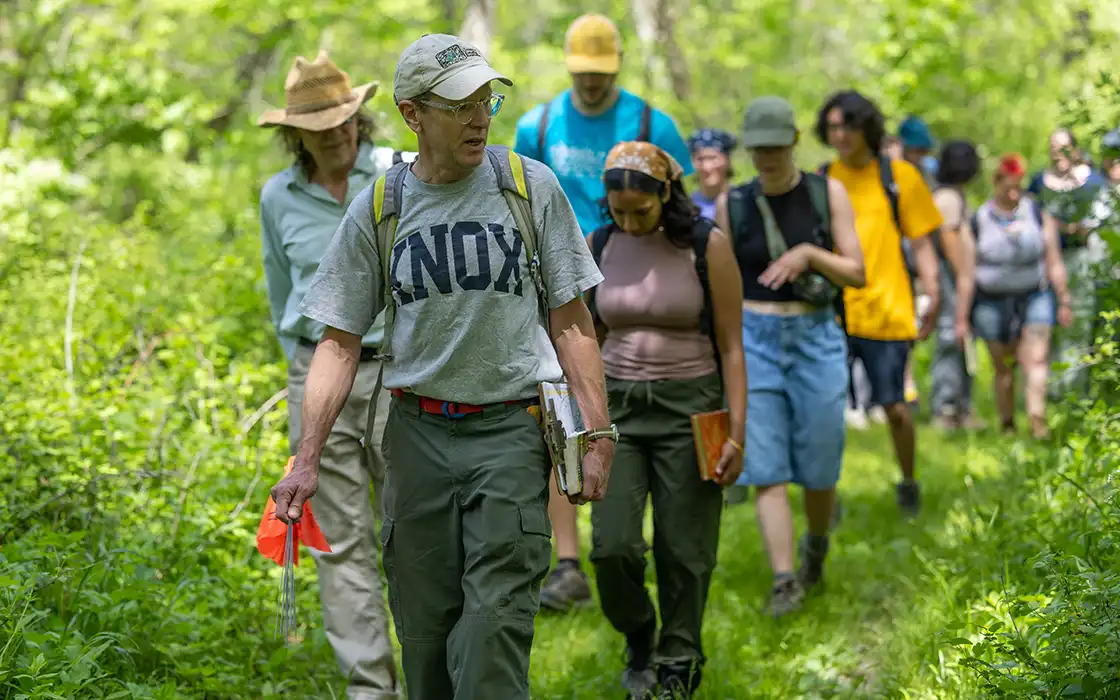 Biology professor and director of Green Oaks, Stuart Allison, leads Knox students on a hiking trail at Green Oaks.