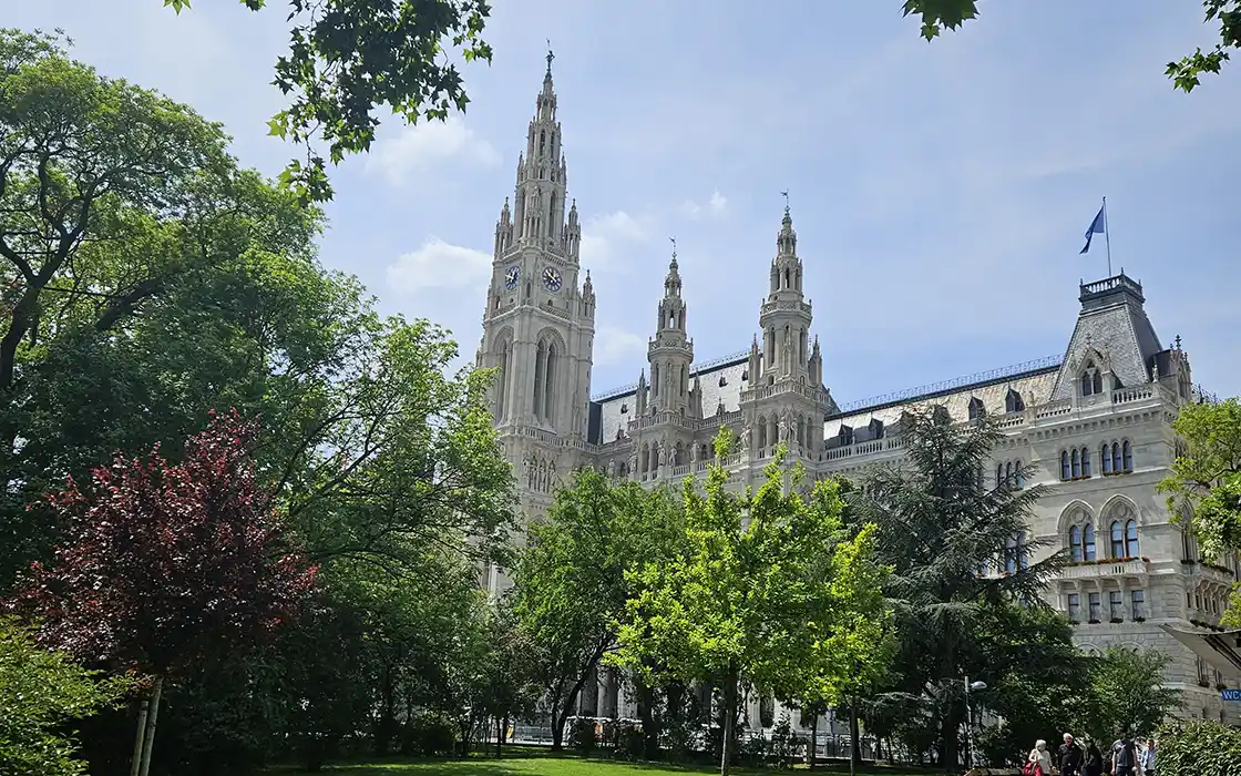Vienna City Hall is pictured—a grand, cathedral-like structure. 