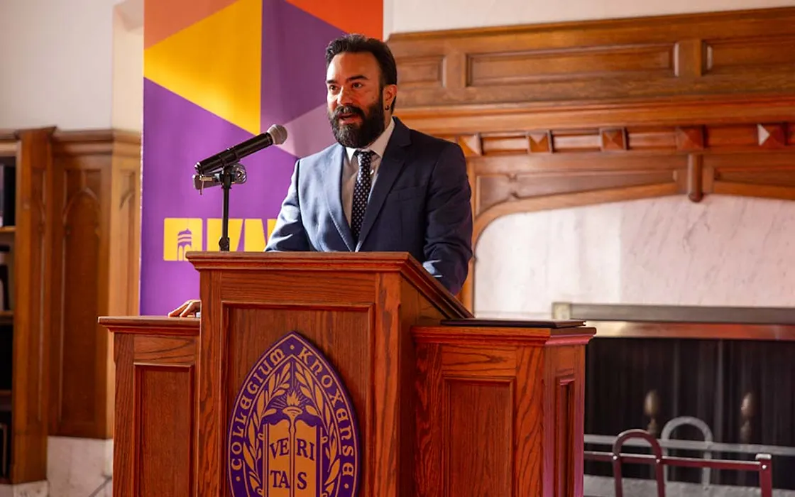 Talip Kilic stands behind a podium and speaks during the 2024 Alumni Achievement Awards Ceremony.