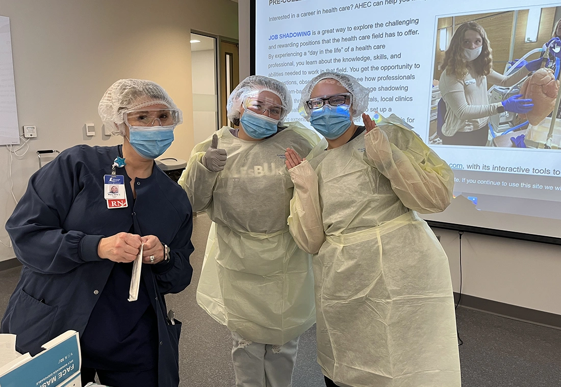 A student works on a CPR doll.