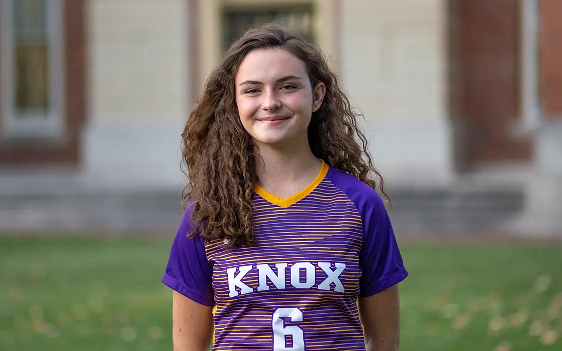Olivia Grierson smiles at the camera, wearing her Prairie Fire uniform.