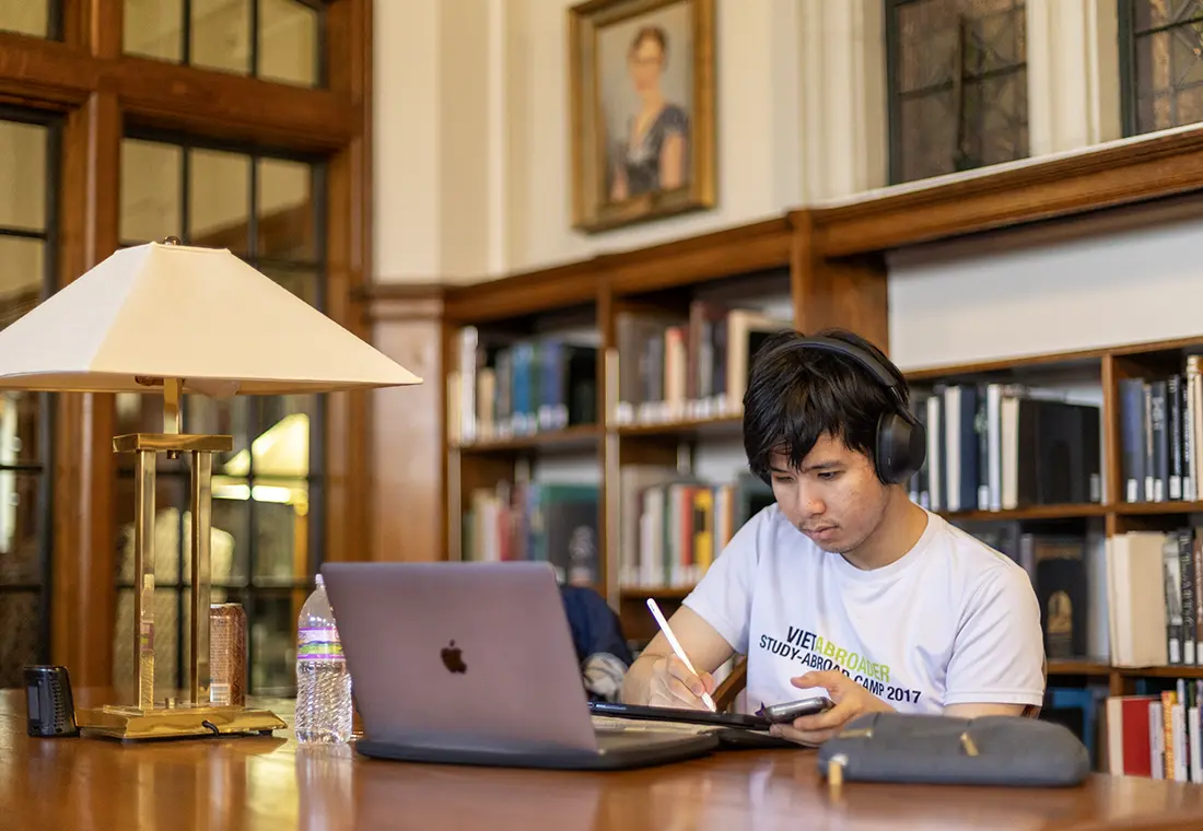 A student studies in front of a laptop computer in Seymour Library. 