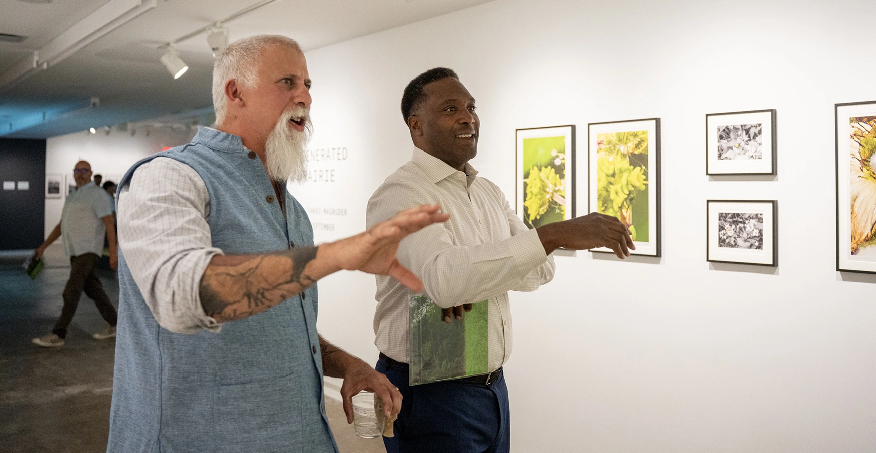 Professor of Religious Studies Robert Geraci and Knox College President C. Andrew McGadney take in and discuss the Re Generated Prairie exhibit. 