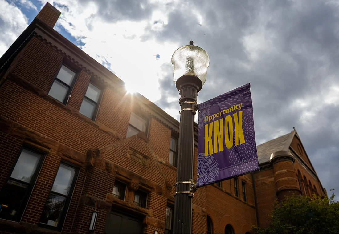 Outside Alumni Hall with a Knox sign outside.