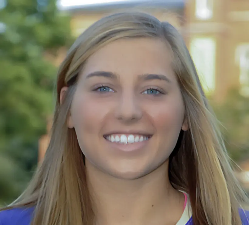 A headshot of Casey smiling at the camera.