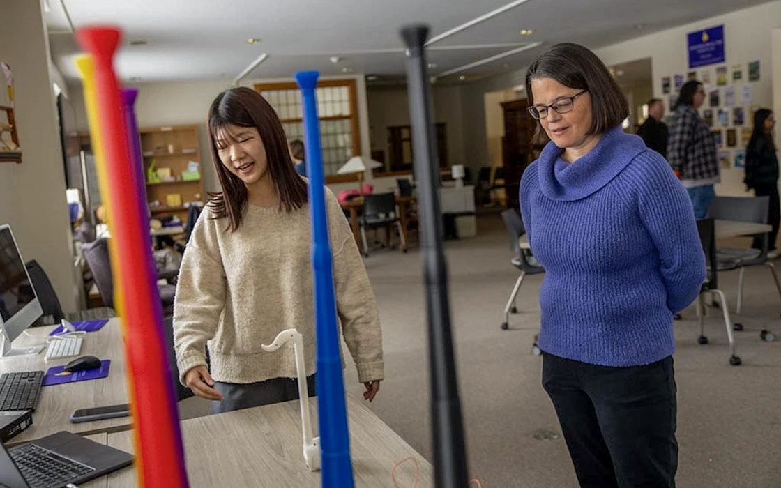 In the Abolition Lab, a student presents a music project to Anne Thomason.