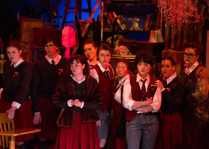 A group of students on stage in costume.