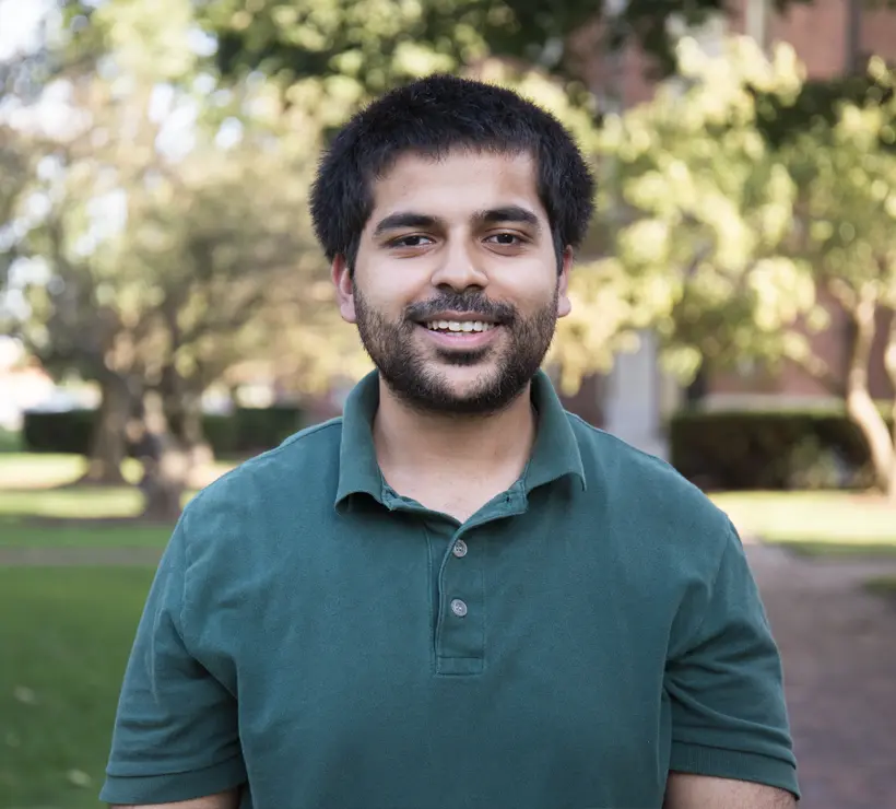 Arsalan Najeeb standing outside smiling at the camera.