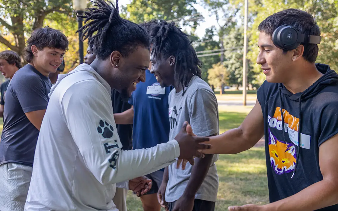 During Pumphandle, students shake hands in a line. 