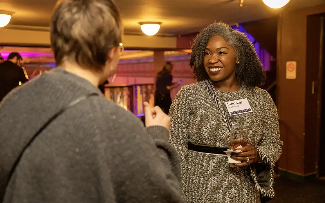 Two women greet each other at a New York Knox Club event.