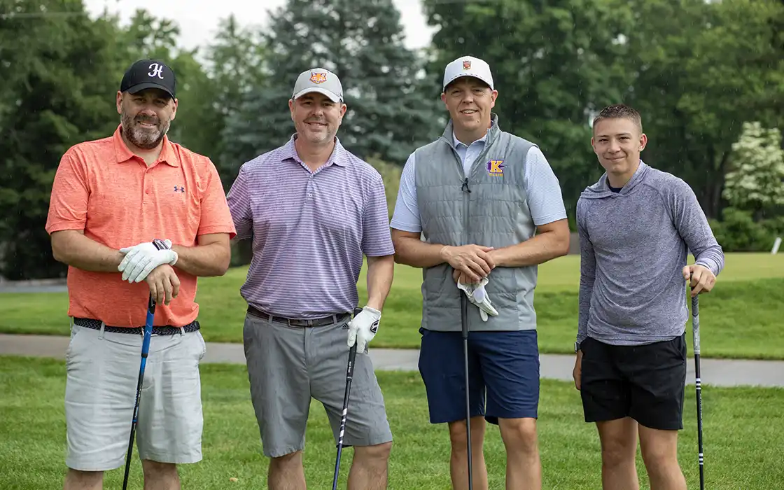 For men in golf gear pose on a gold course during the annual K Club Golf Outing.